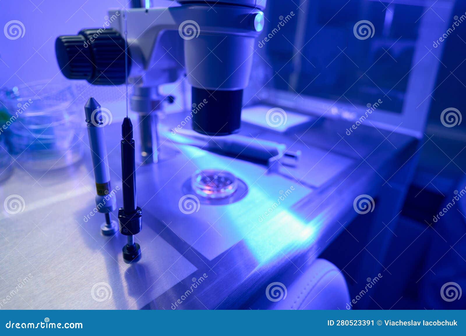 Two Syringes for in Vitro Fertilization Standing Near Microscope Stock