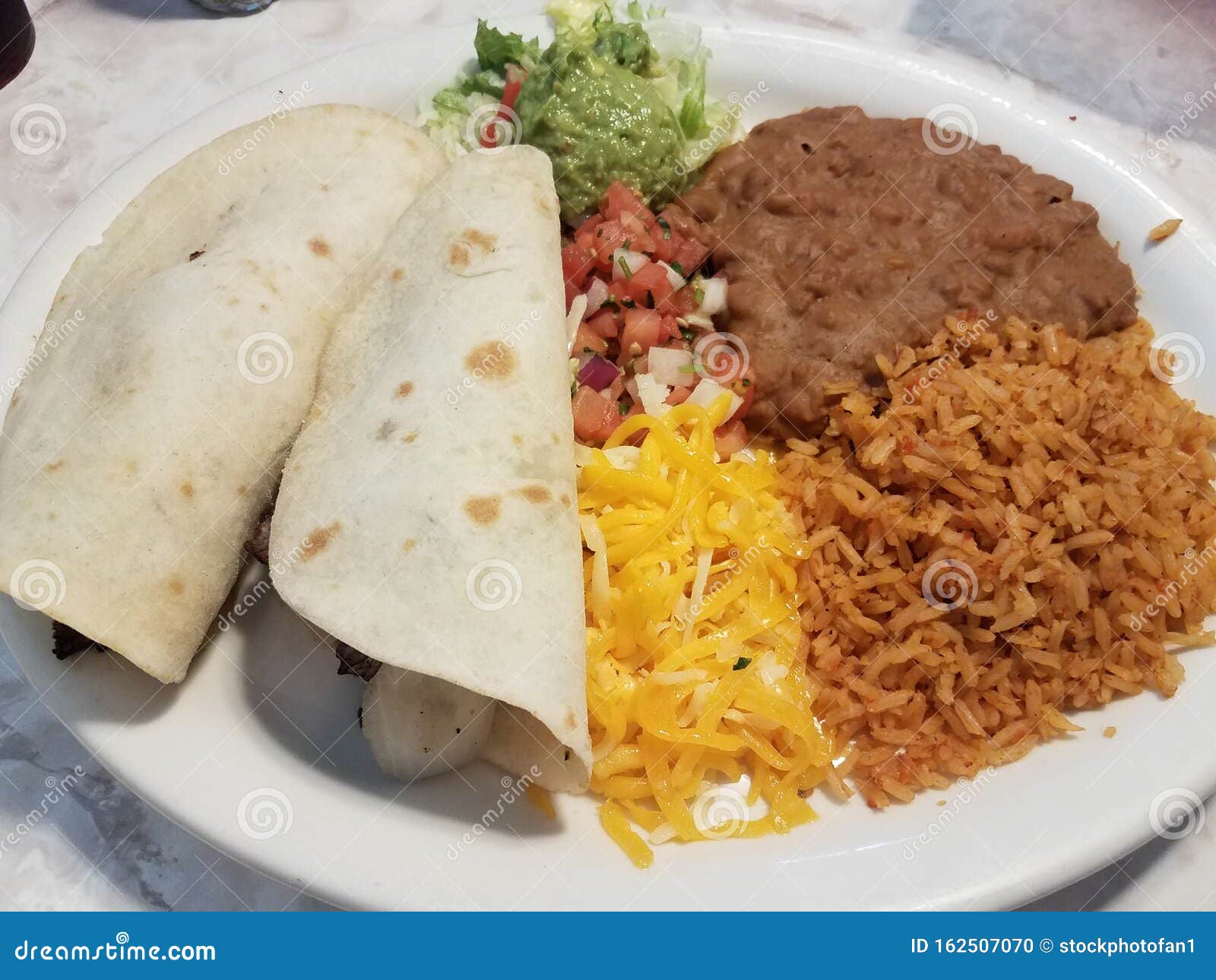 Two Tacos and Rice and Beans and Cheese on Plate Stock Photo Image of