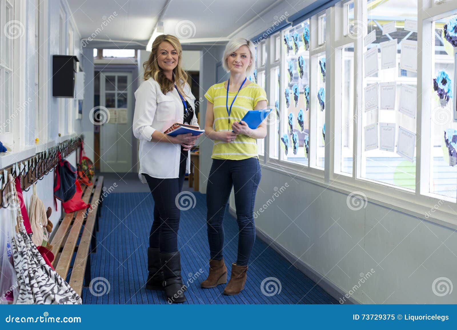 two teachers in school corridor