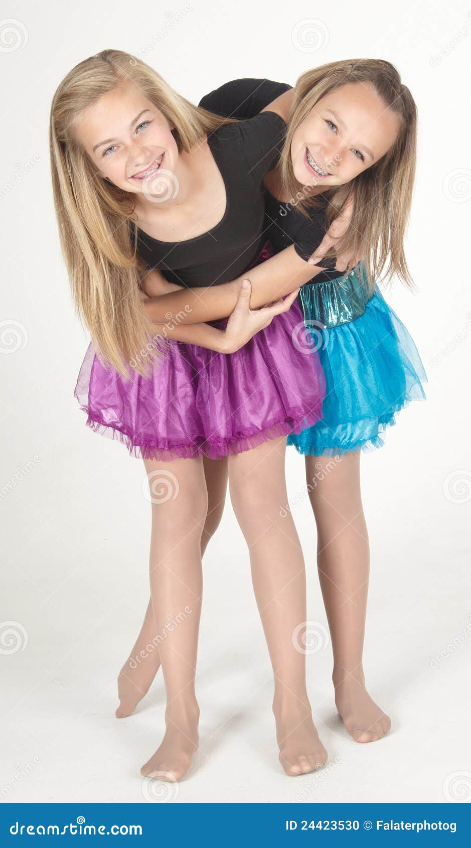 two teen girls modeling fashion clothes in studio