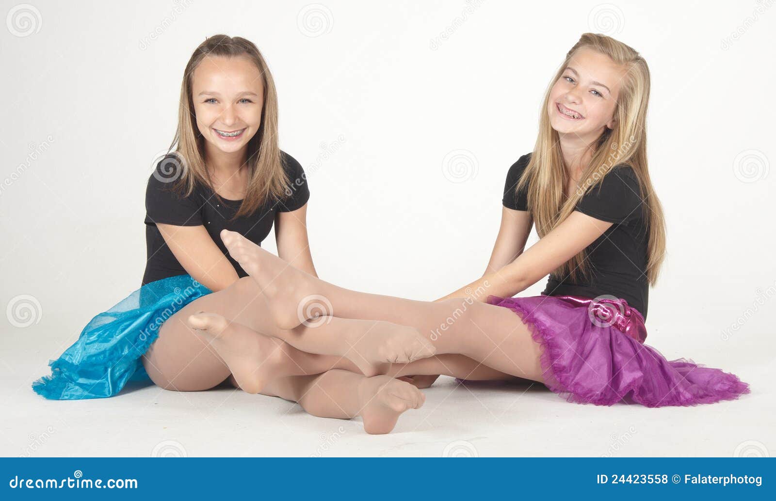 two teen girls modeling fashion clothes in studio