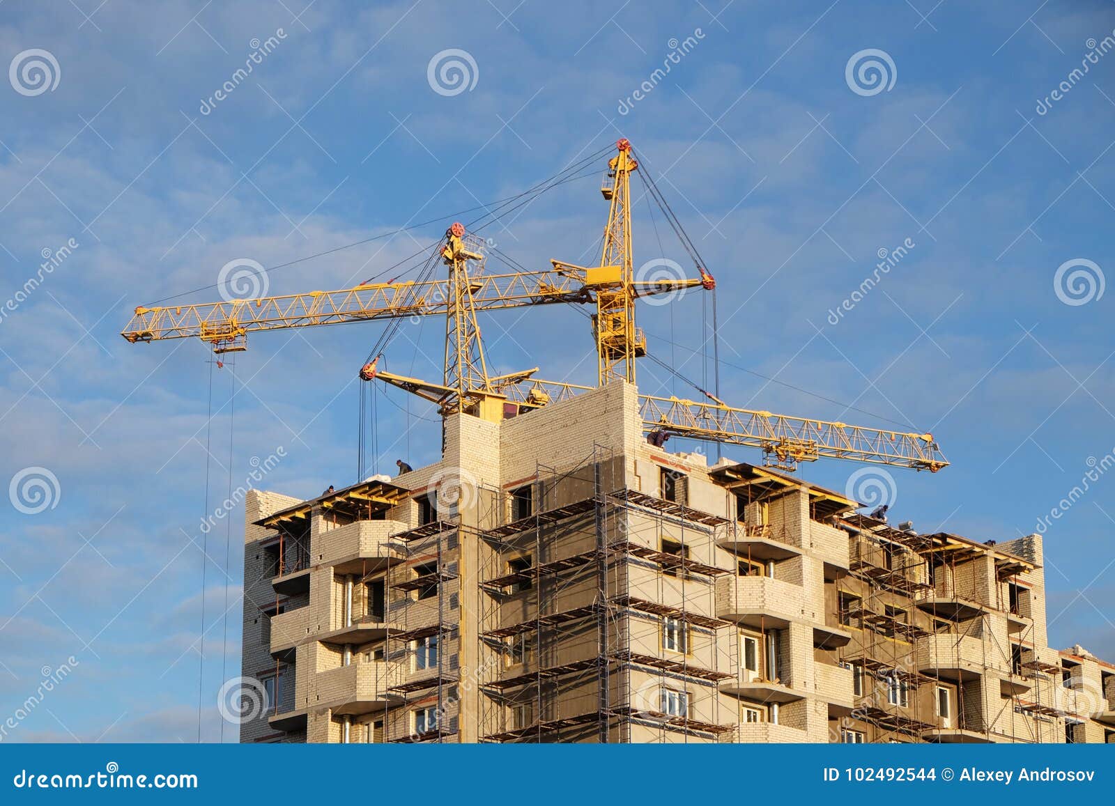 two tower crane at a construction site in the autumn