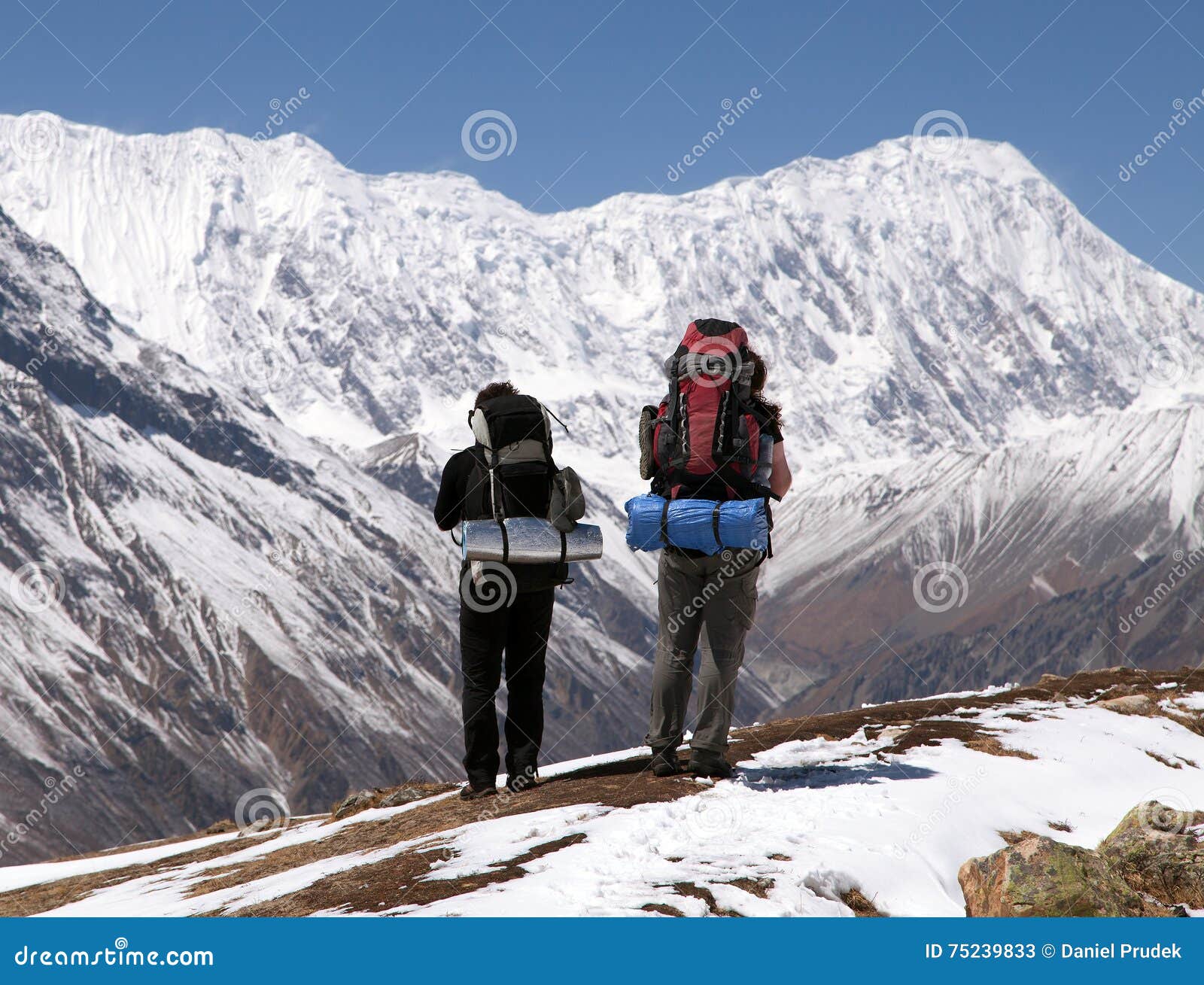 two trekkers and mount tilicho