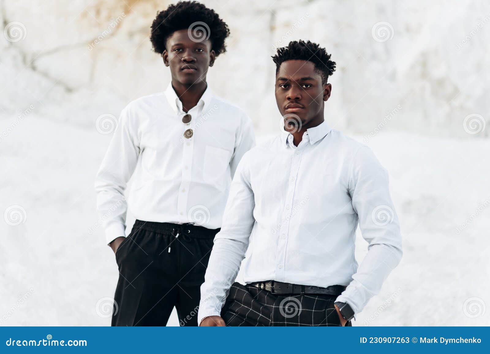 two trendy black men, fashion portrait of african american male models, in white shirts, outdoors