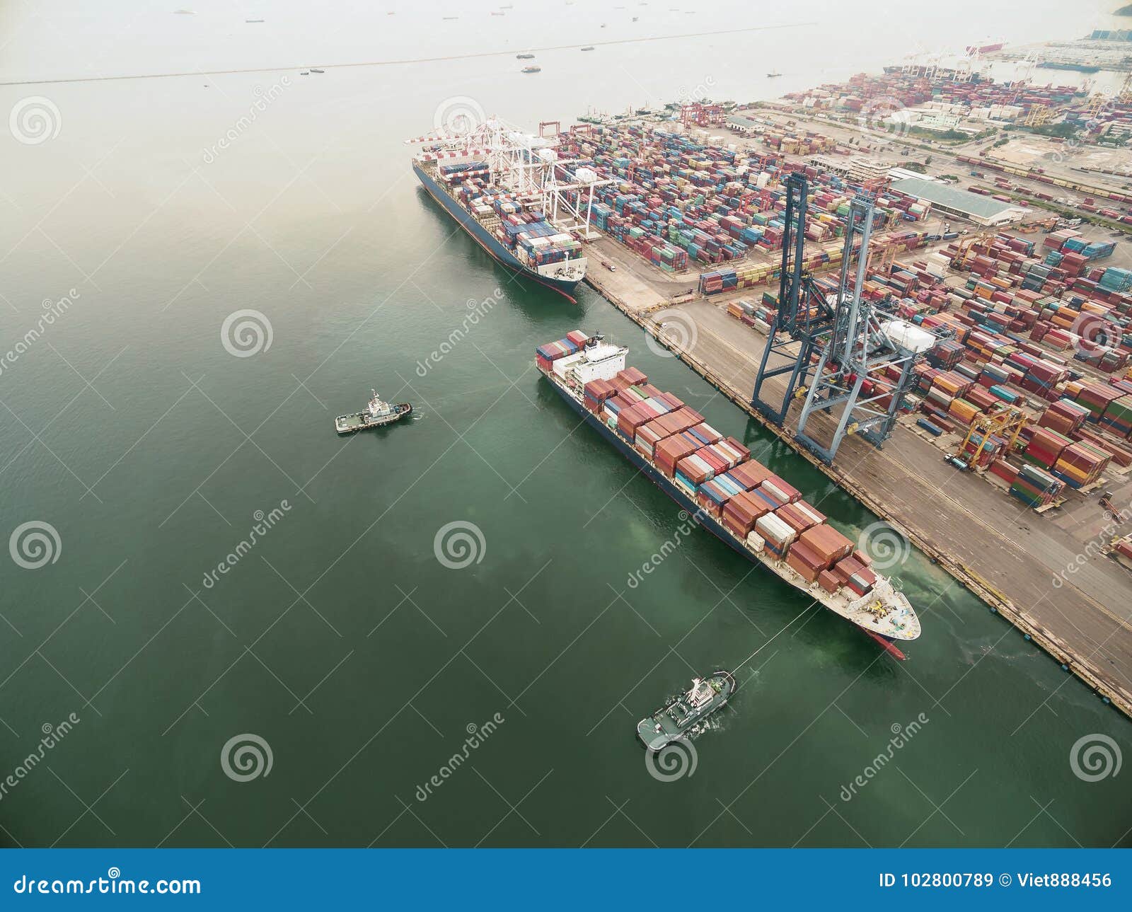 Two Tug Boat Towing Cargo Container in Warehouse Harbor at Thailand
