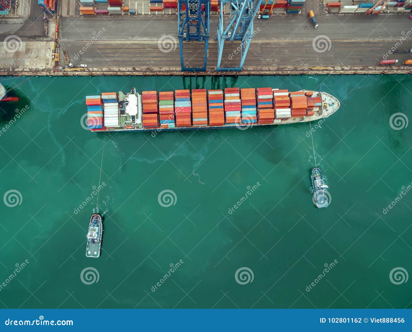 Two Tug Boat Towing Cargo Container In Warehouse Harbor At Thailand