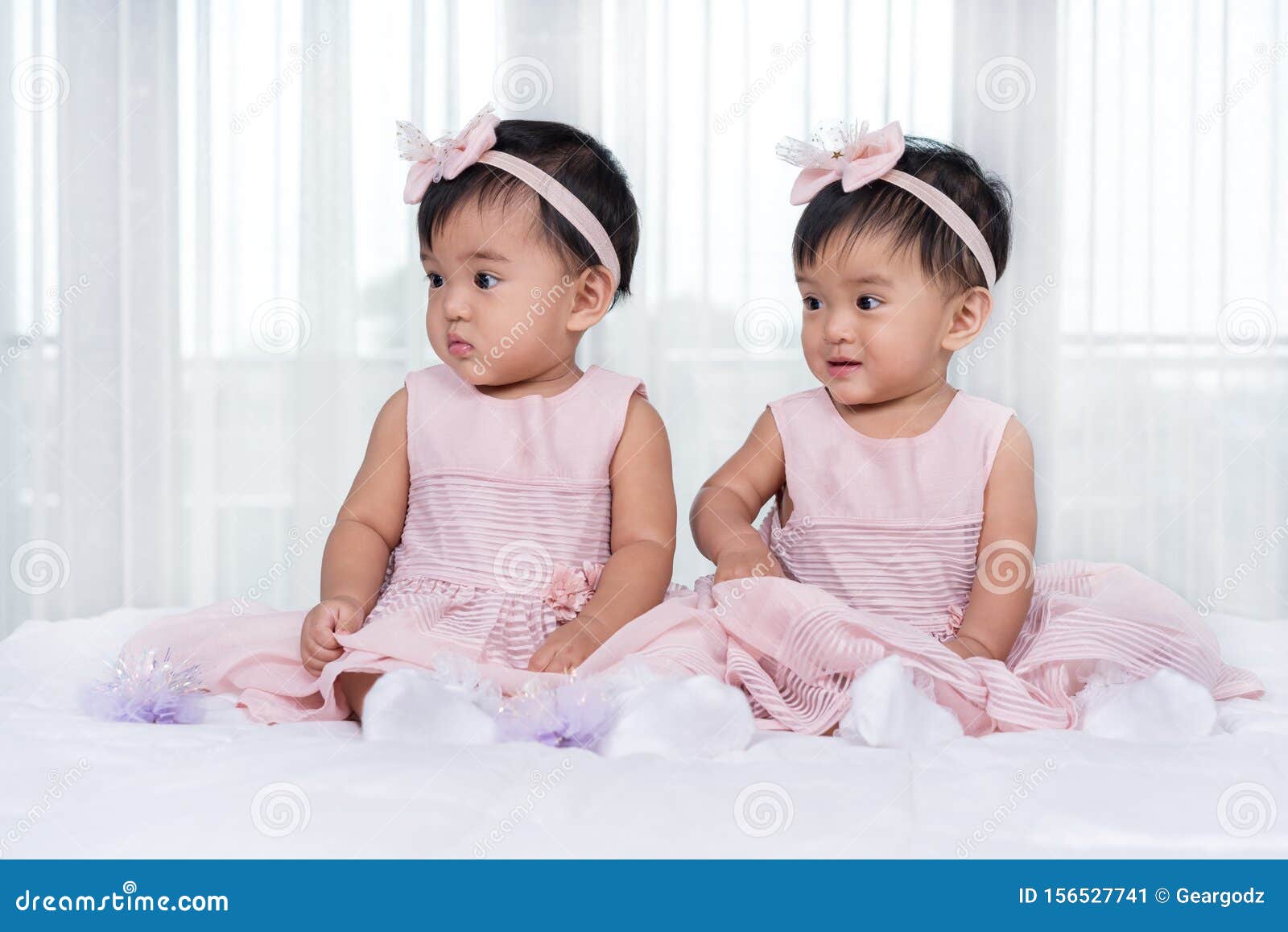 Two Twin Babies in Pink Dress on Bed Stock Image Image of happy
