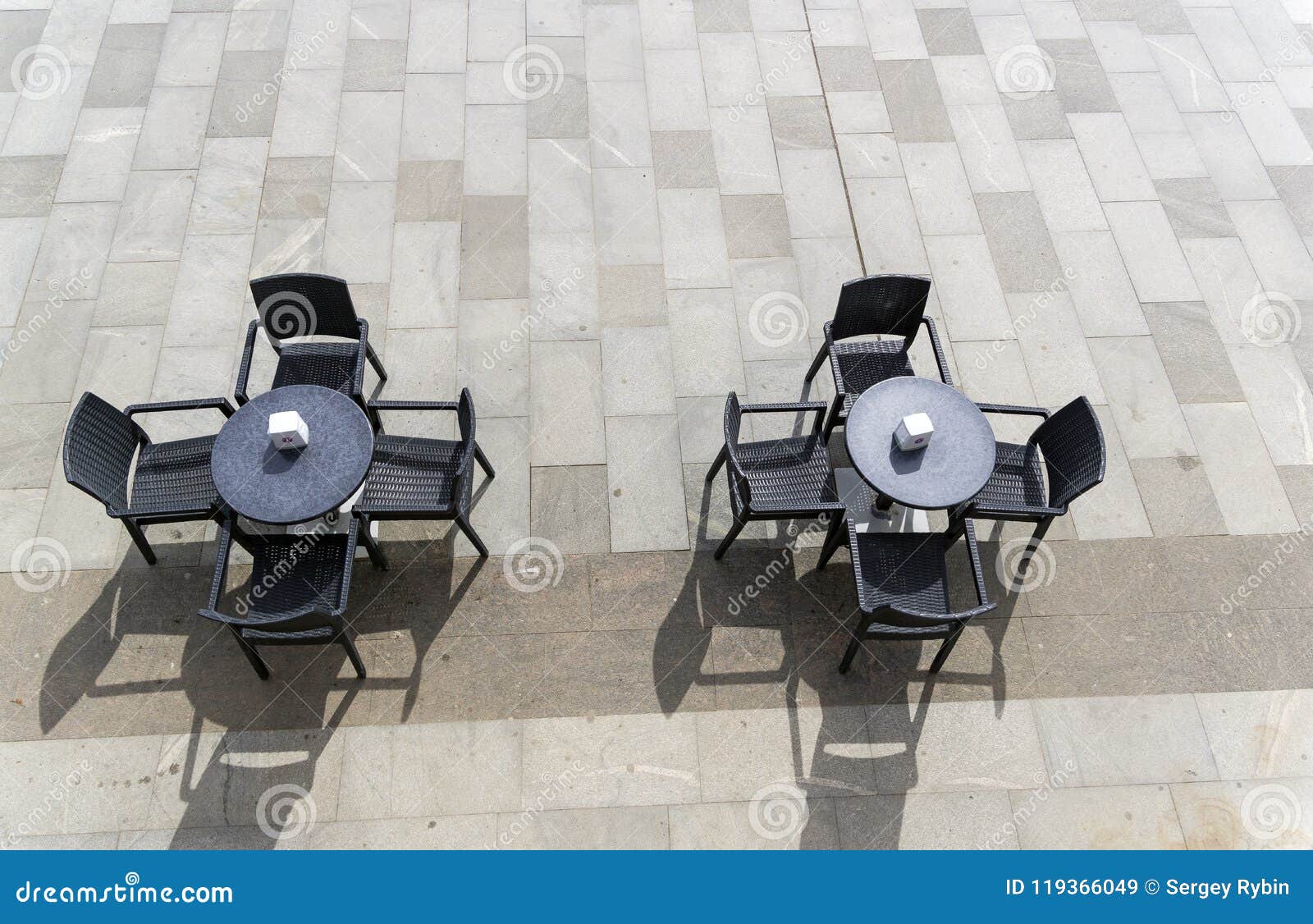 two unoccupied tables in a street cafe.