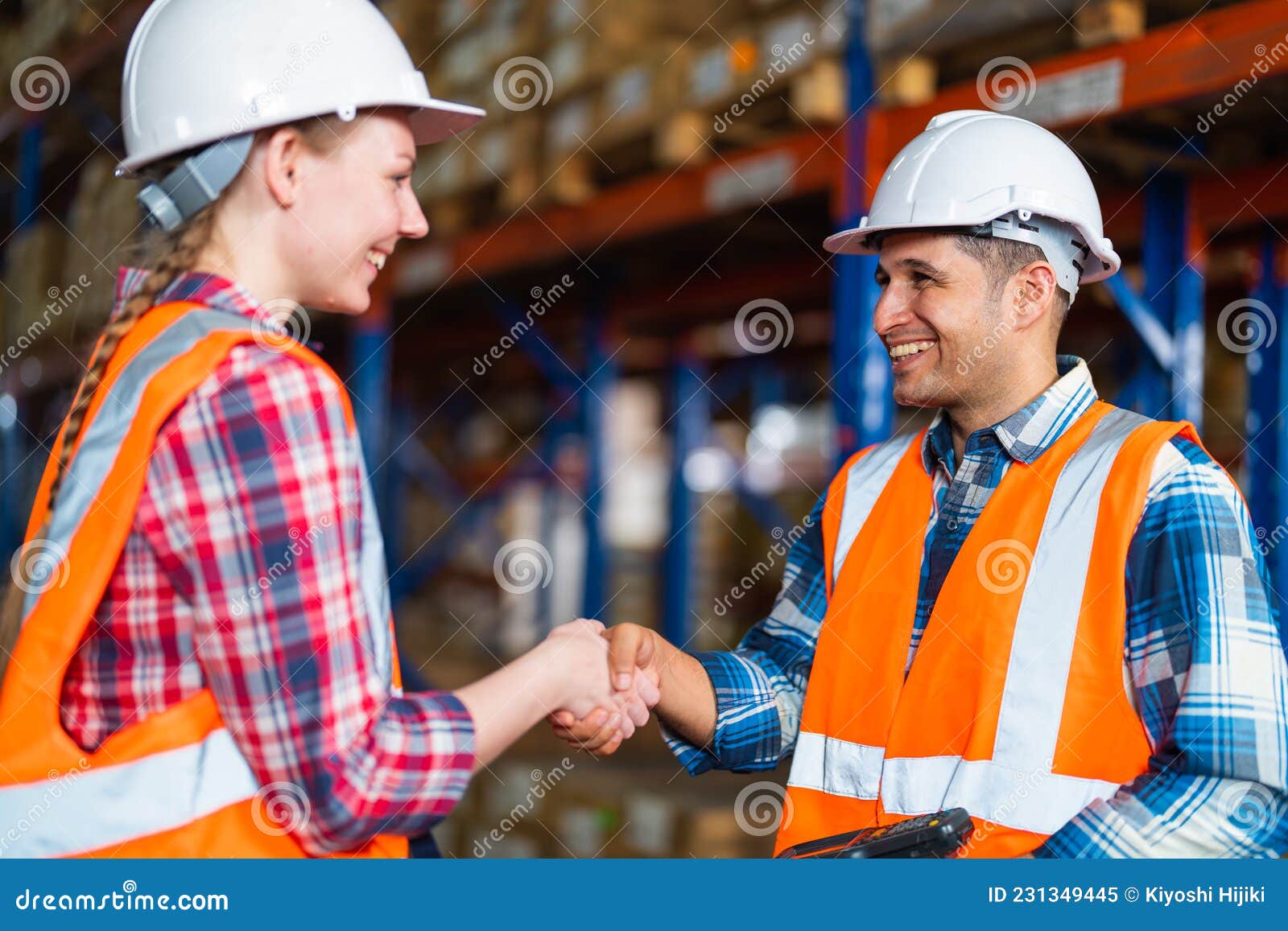 Two Warehouse Workers Shaking Hand when Success Project or First Time