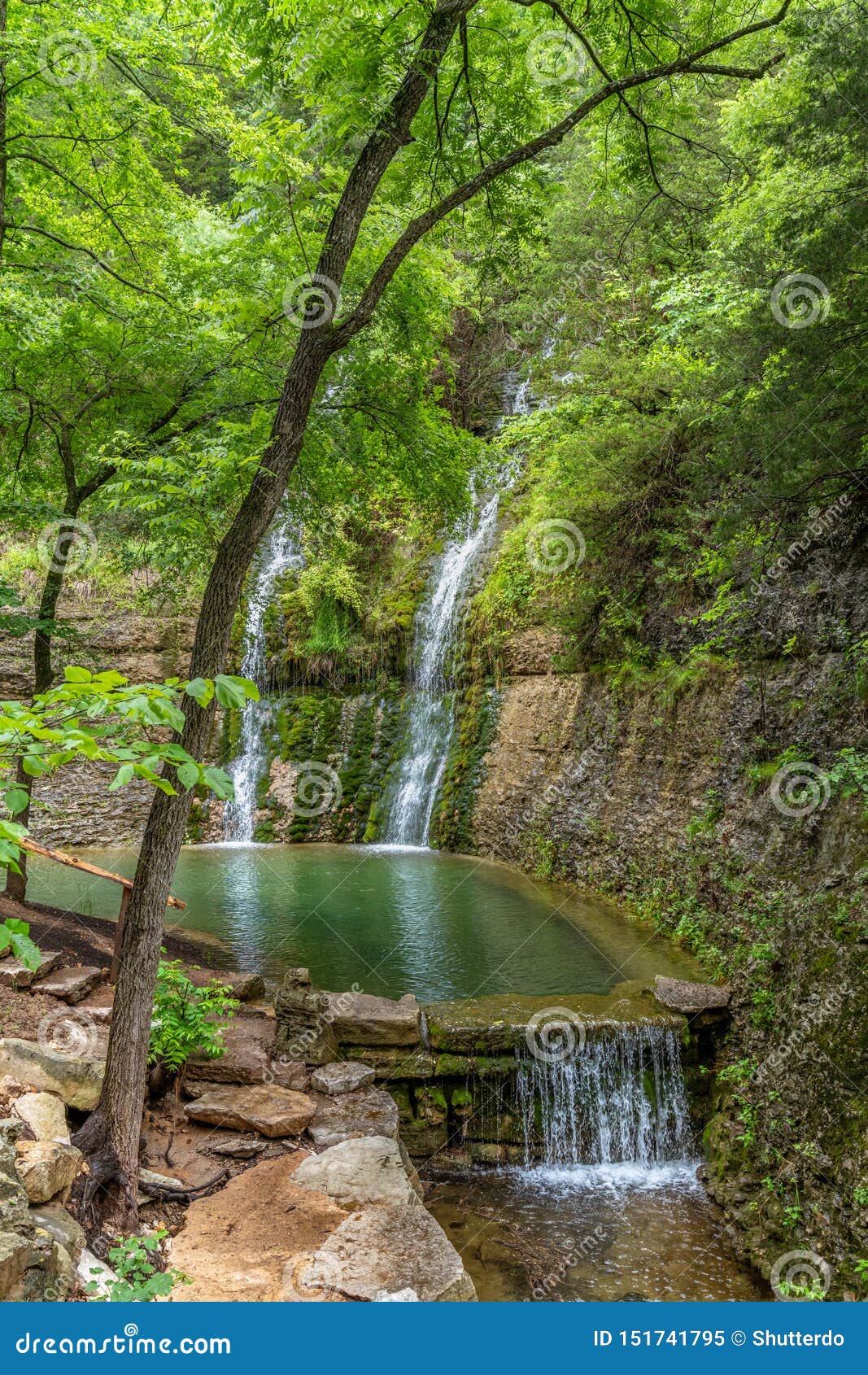 Two Waterfalls Cascading Down The Canyon Walls Into A