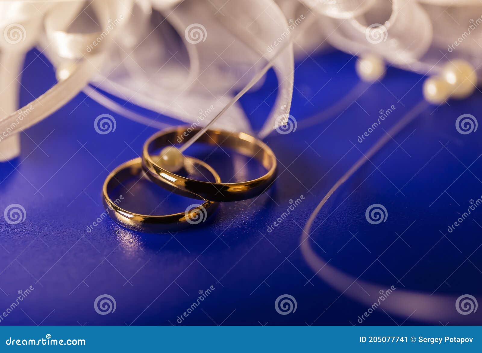 Two Wedding Rings on a Blue Background Stock Image Image of ceremony