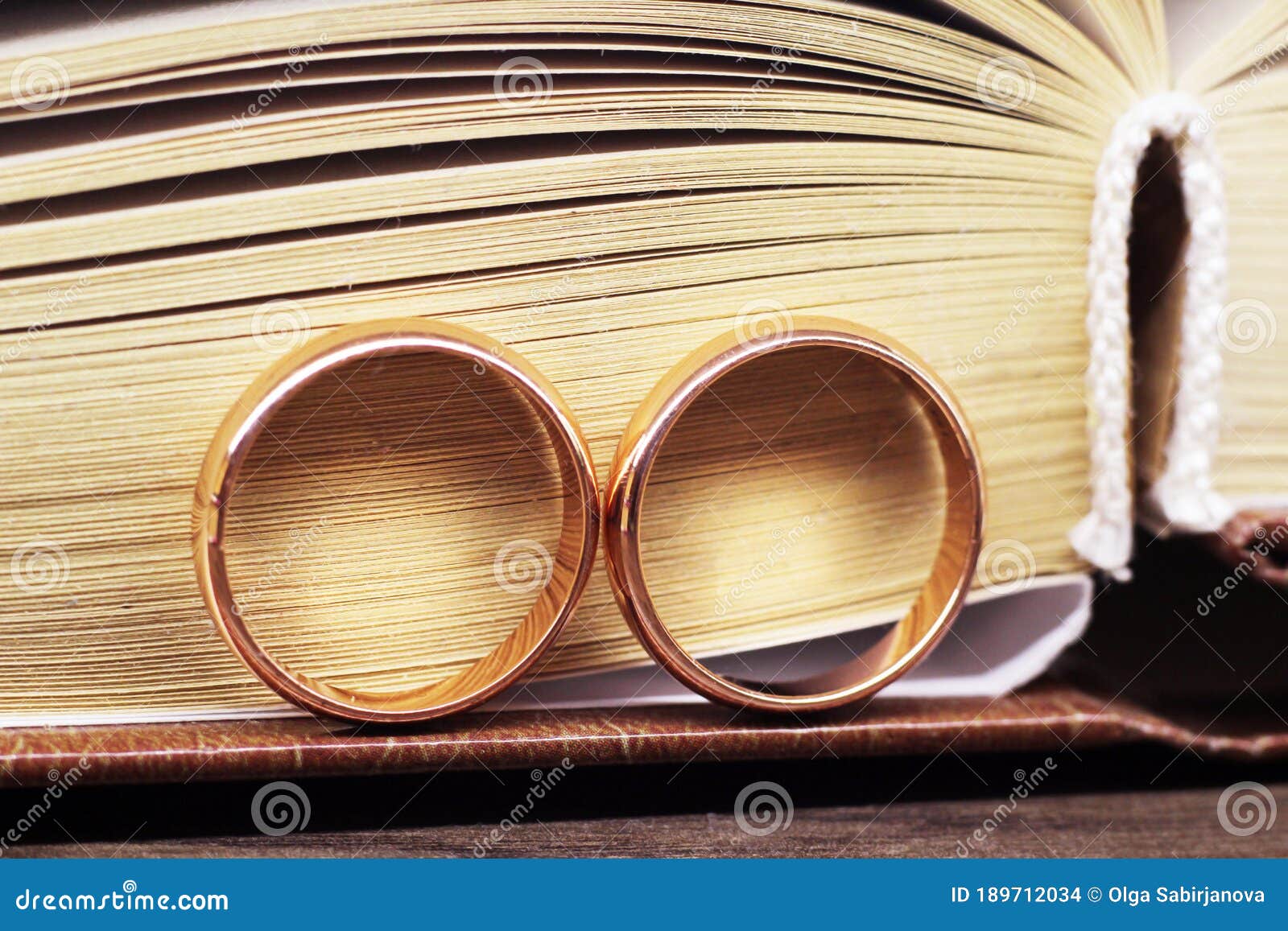 Two Wedding Rings on a Book Stock Photo Image of jewelry, love 189712034