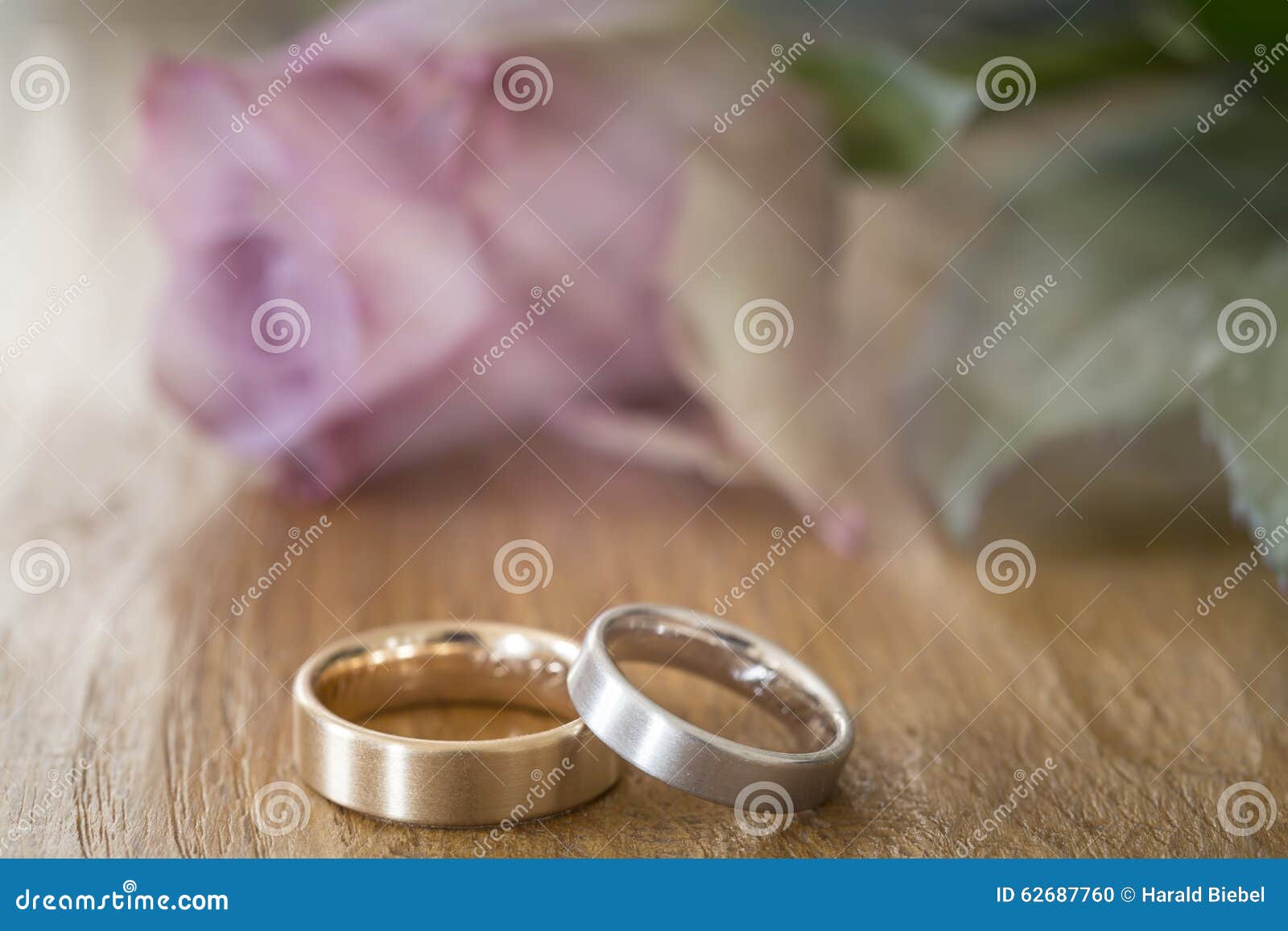 Two Wedding Rings on a Wooden Surface with Rose Stock Photo - Image of ...
