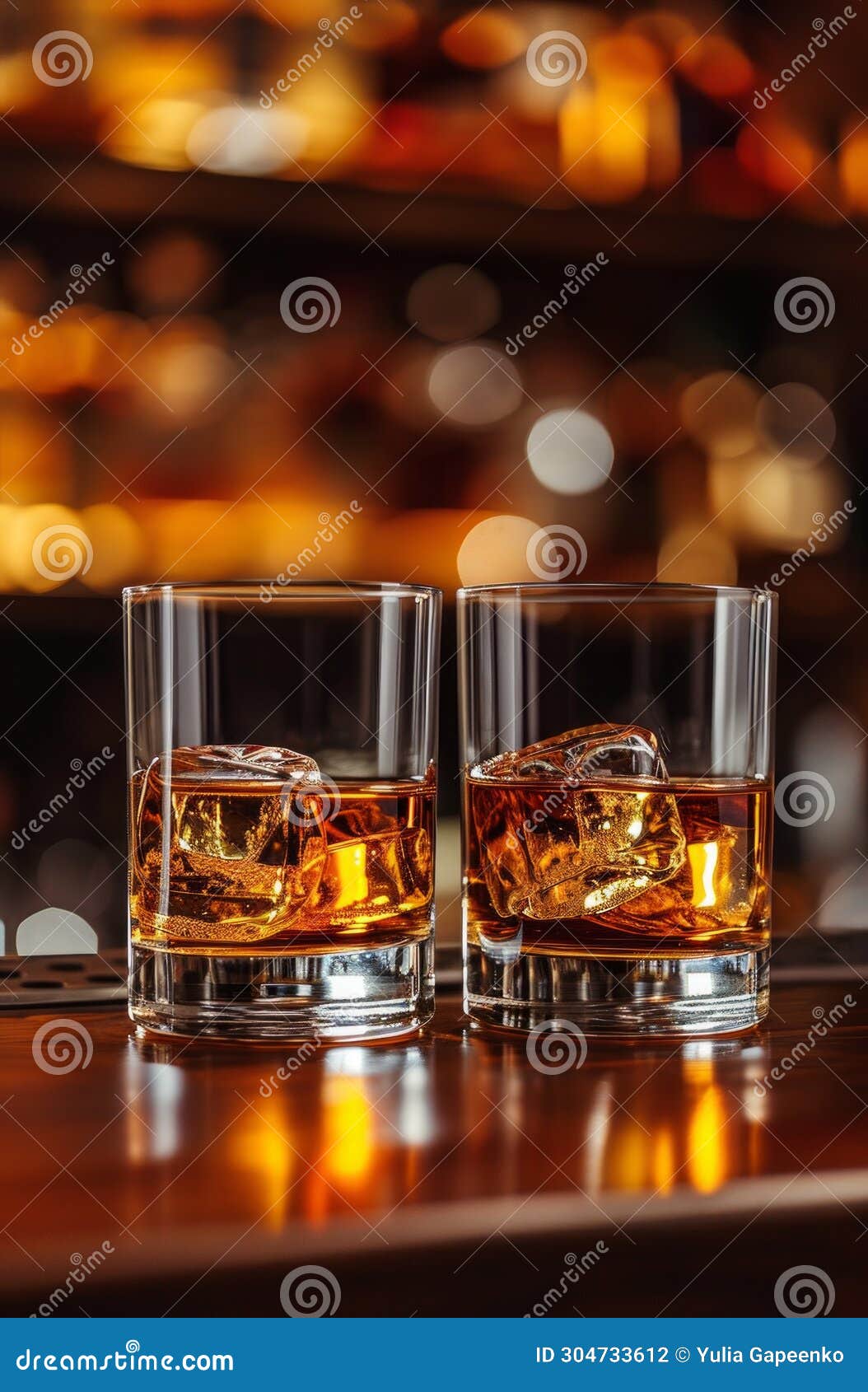 Two Whiskey Glasses on a Bar Showing Different Whiskeys Stock Photo