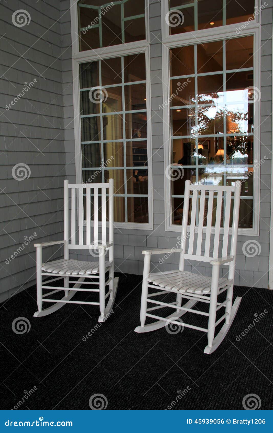 Two White Adirondack Rocking Chairs On Front Porch Stock 