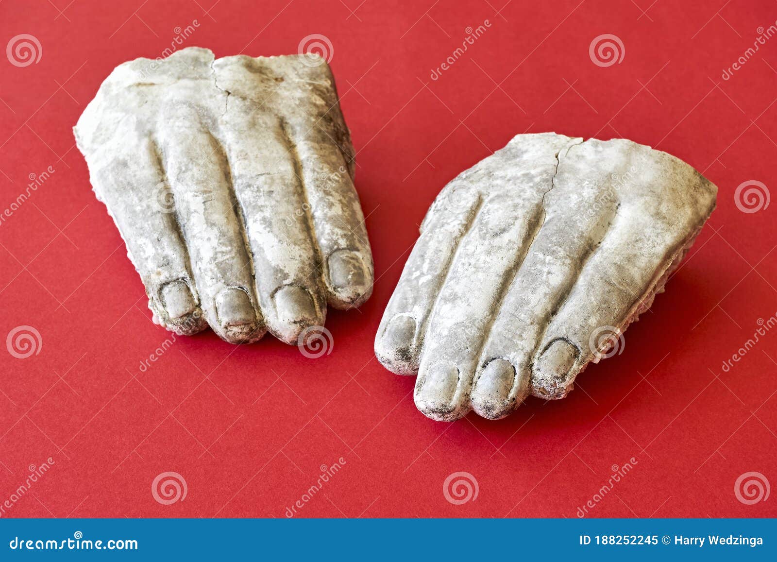 two white broken hands of a stone statue