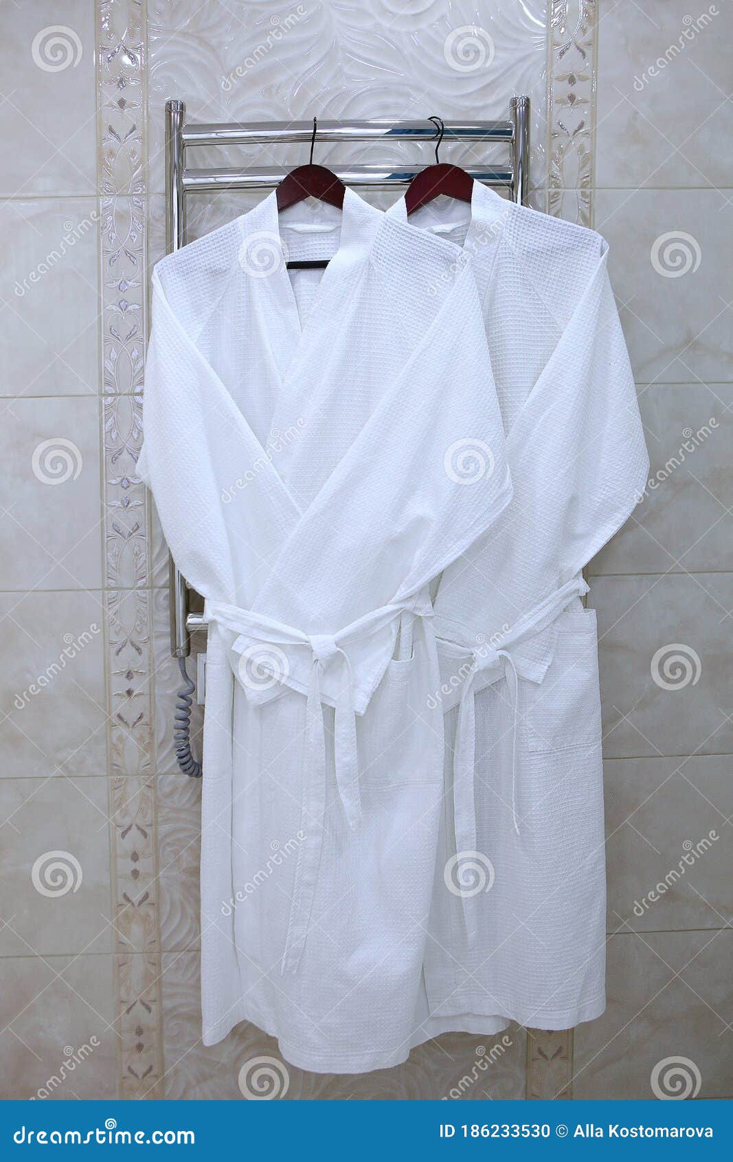 Premium Photo | Portrait of beautiful bride in white silk dressing gown  with curly hairstyle and long veil standing near window in bedroom, copy  space