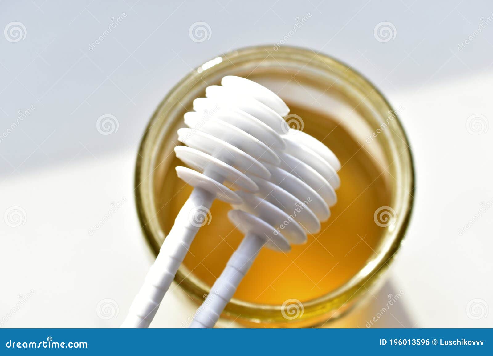 Two White Plastic Spoons for the Honey Stock Photo Image of drop