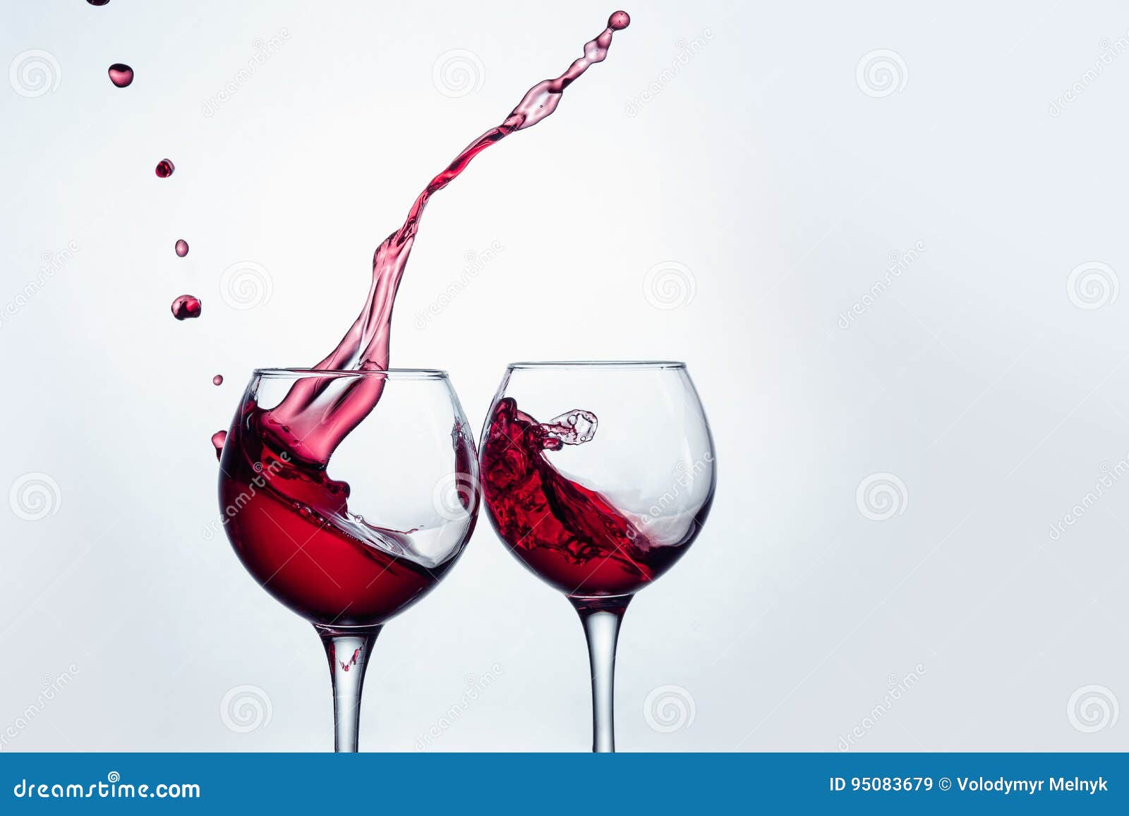 Two Wine Glasses in Toasting Gesture with Big Splashing. Stock Image