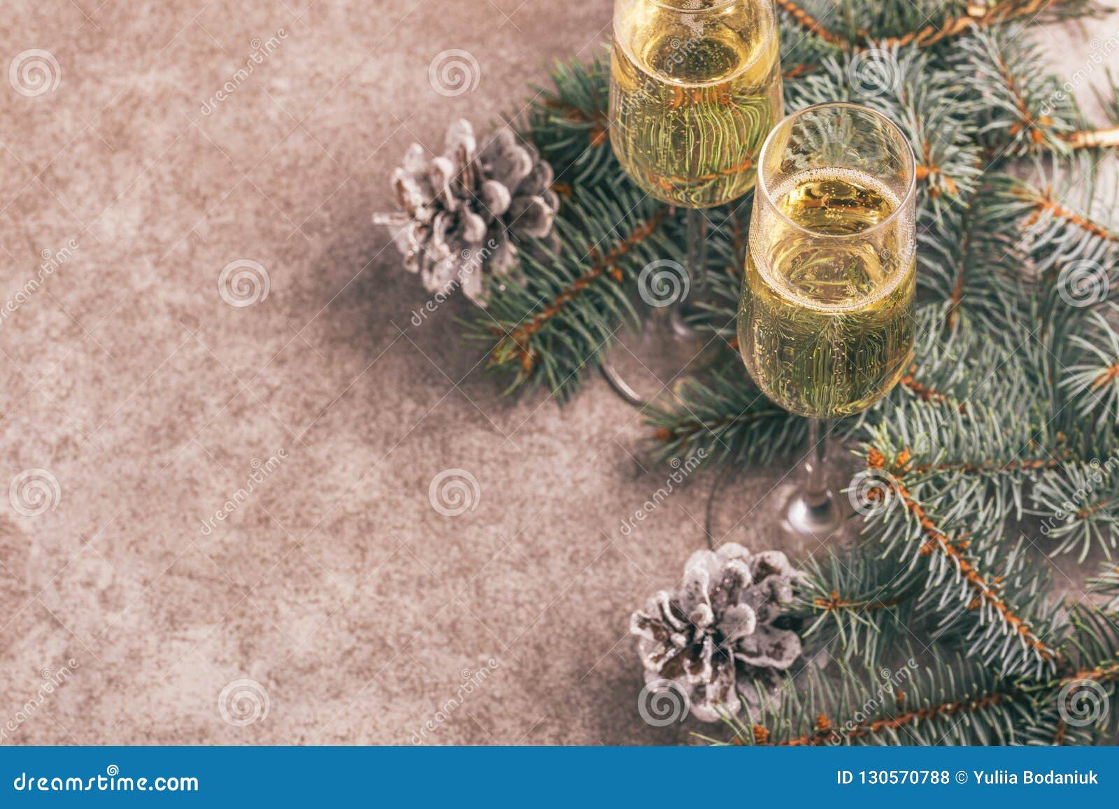 two wineglasses of champage with christmas tree branches