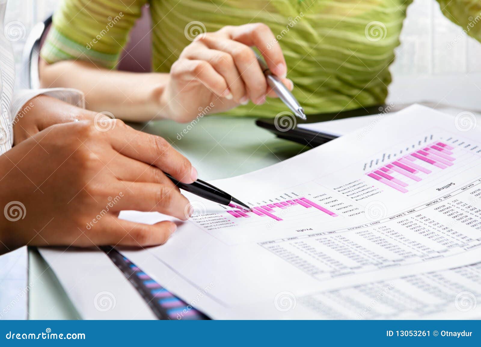 two woman working on statistic