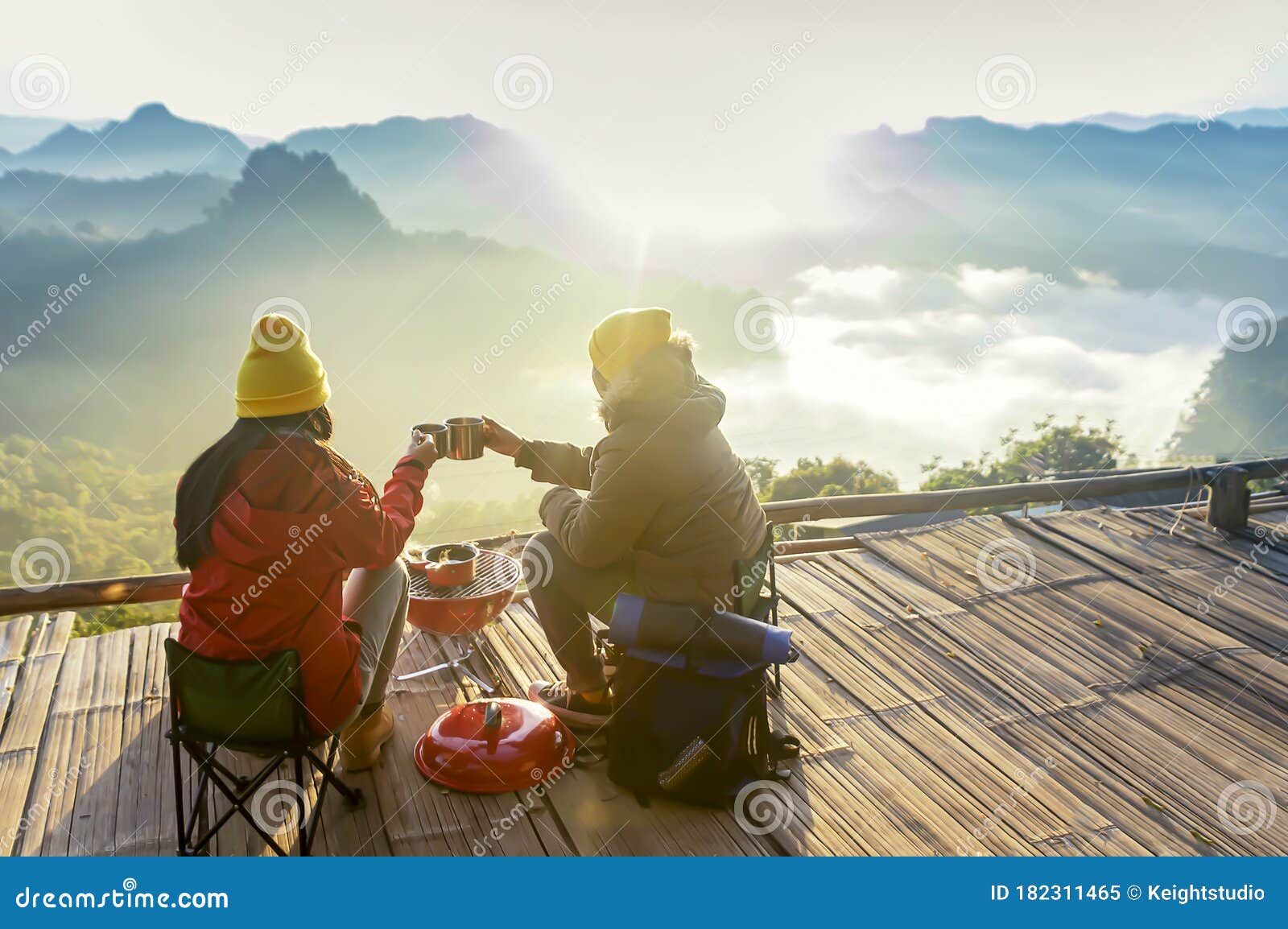 Two Women Camping in the Mountains and Drinking Coffee Stock Image