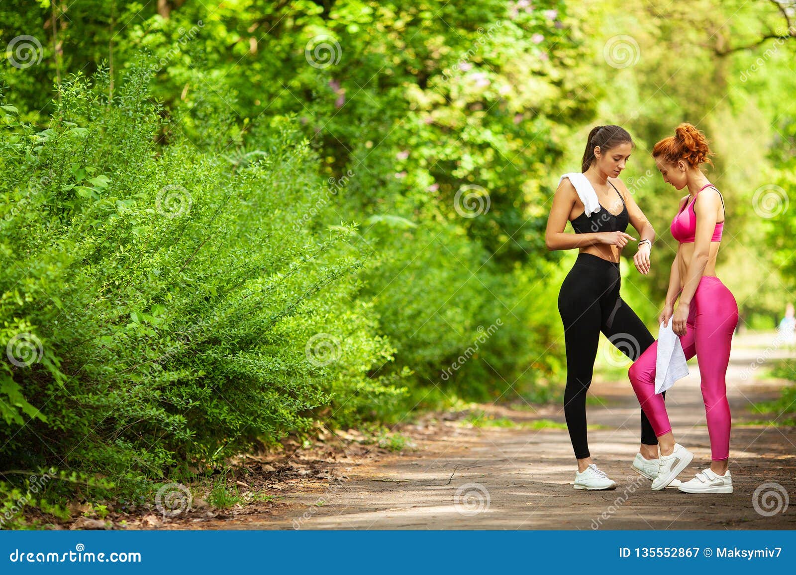 Two Women Exercising In The Park Young Beautiful Woman Do