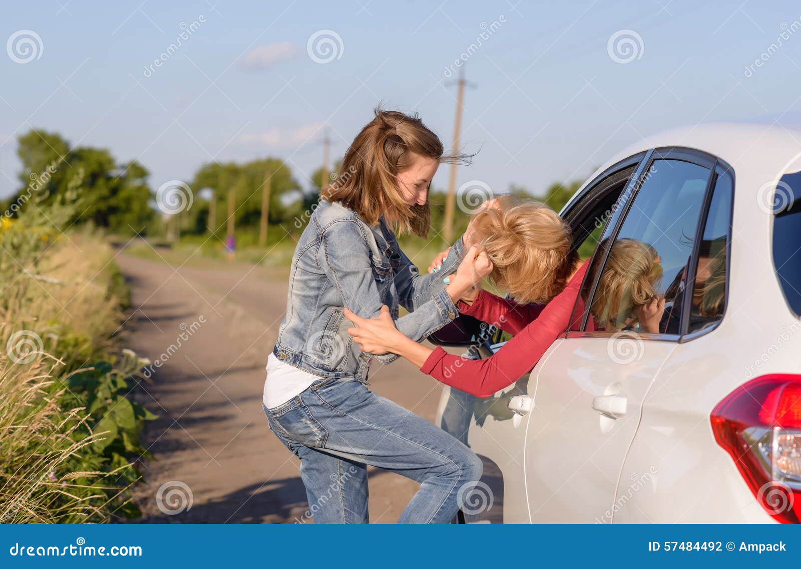 two women fighting at the roadside