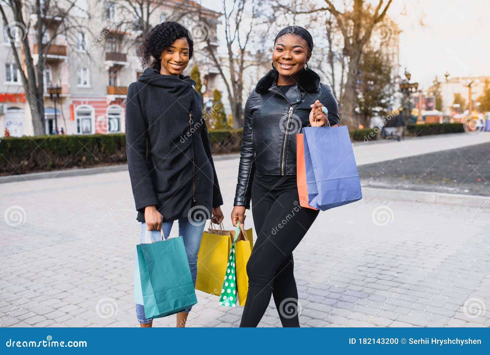 Two Women Friends in the City on a Shopping Trip Carrying Colorful ...