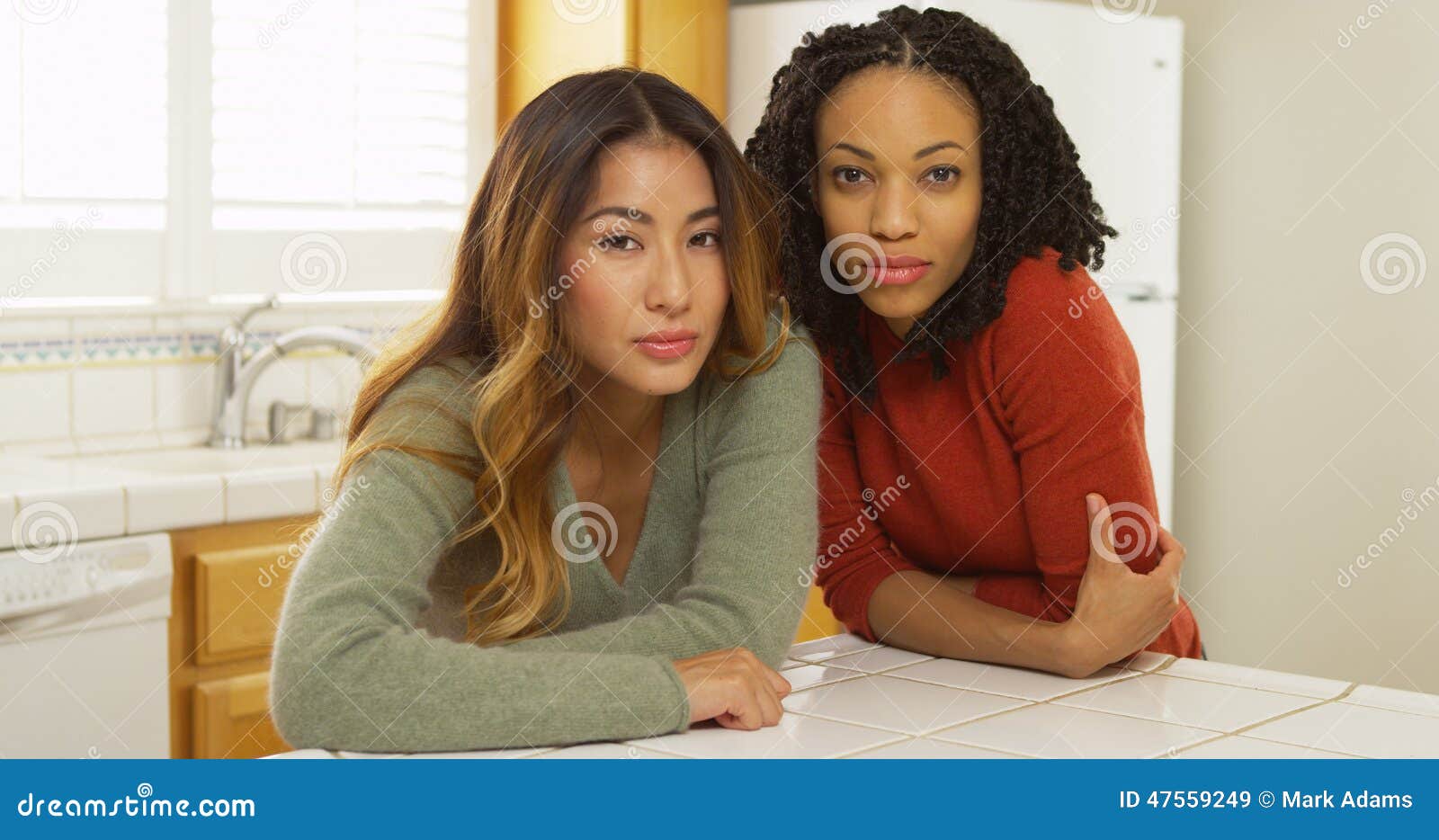 Two Women Leaning Against Kitchen Counter Looking At Camera Stock Image Image Of Leaning 