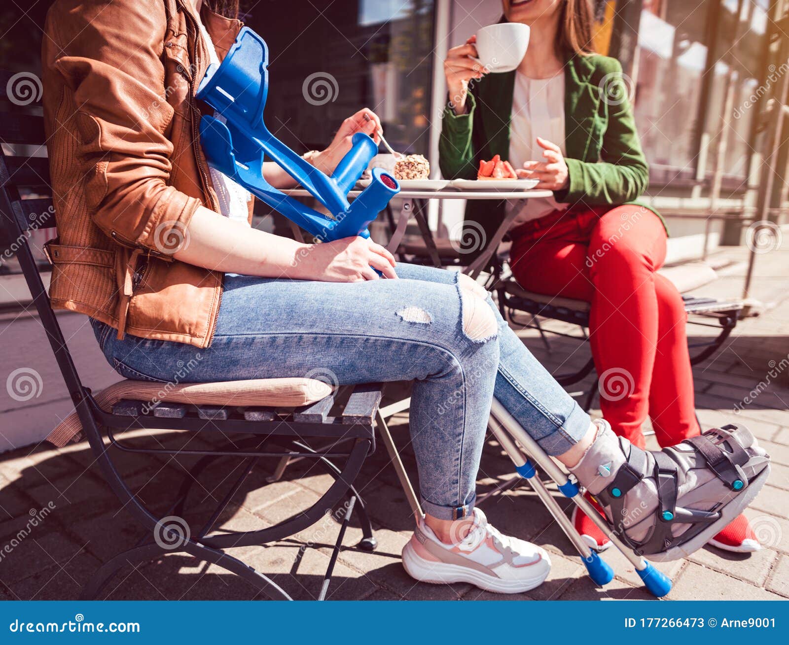 Two Women One With A Broken Leg And Crutches In A Cafe Stock Image Two Women One With A Broken Leg And Crutches In A Cafe Stock Image