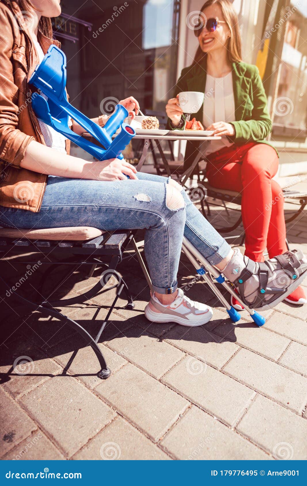 Two Women One With A Broken Leg And Crutches In A Cafe Stock Image Two Women One With A Broken Leg And Crutches In A Cafe Stock Image