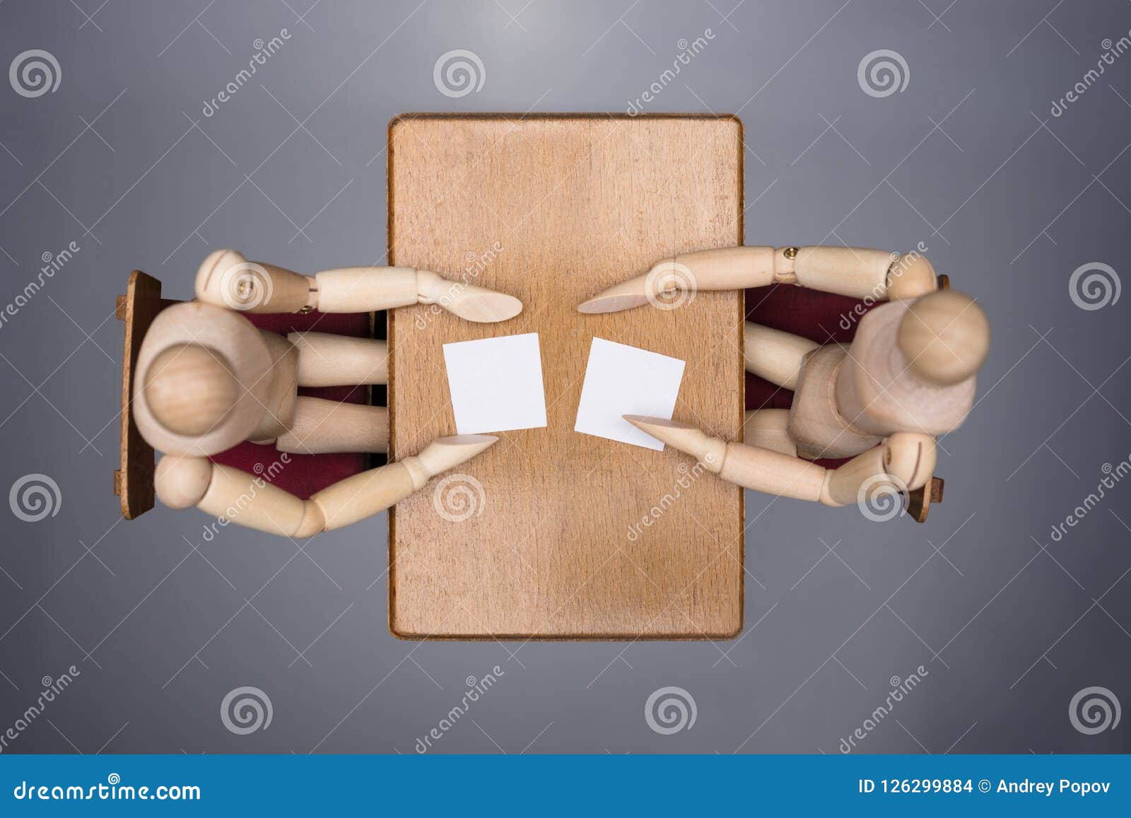 two wooden dummy figures at interview