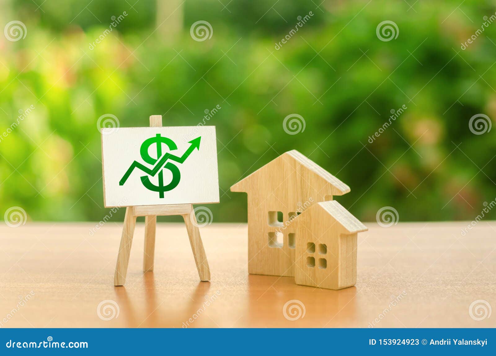 two wooden houses and a green up arrow on the sign. real estate value increase. rising prices for housing, building maintenance.