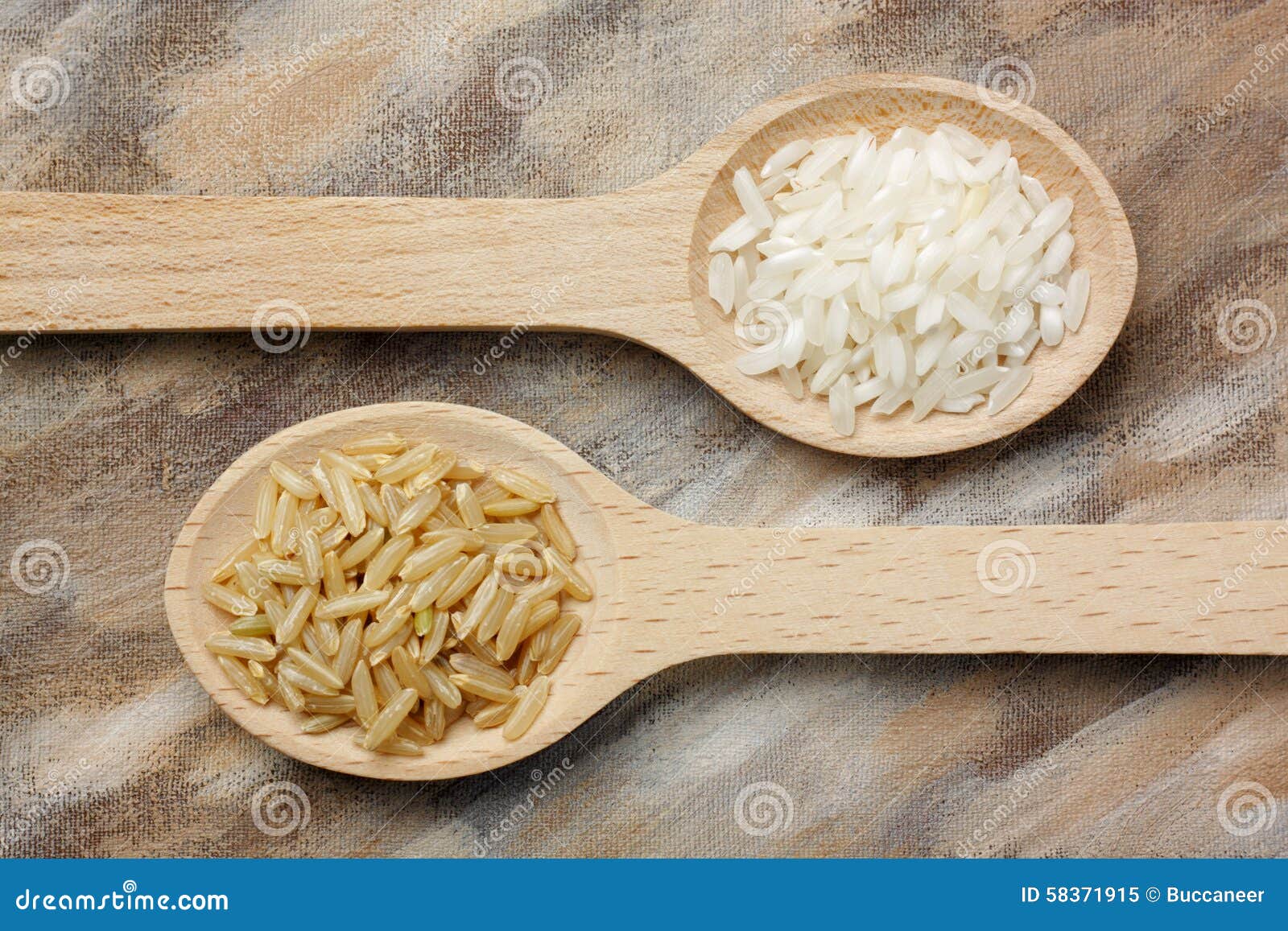 two wooden spoons with white and brown rice grains
