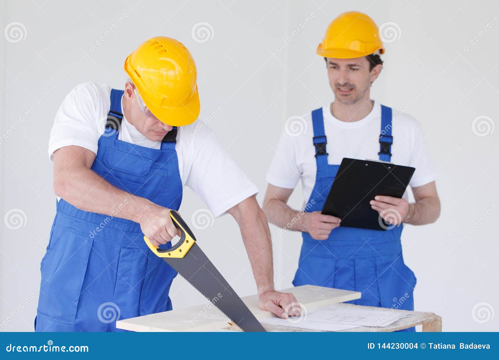 Two workers with hand saw stock photo. Image of contract 144230004