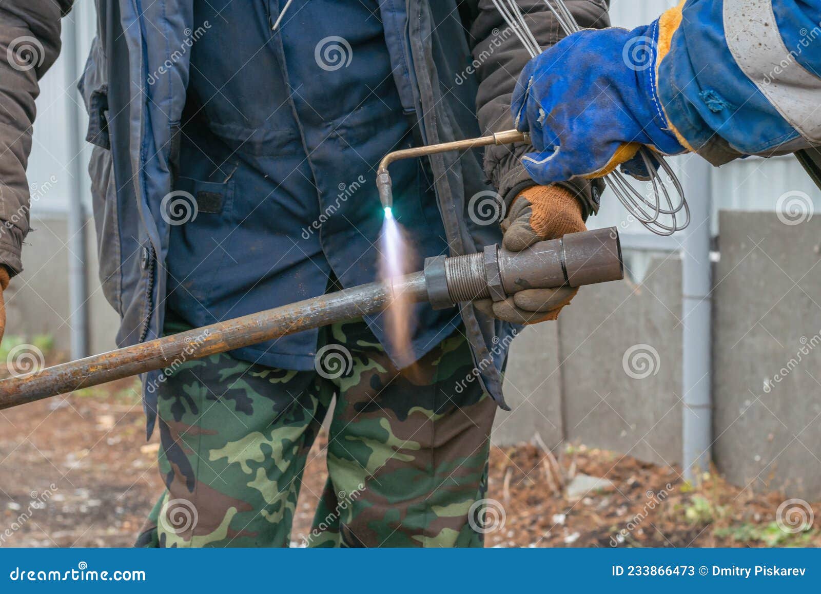 Using An Acetylene Gas Torch Two Workers Connect Two Metal Parts In