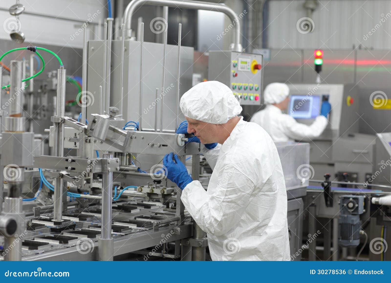 two workers at production line in plant