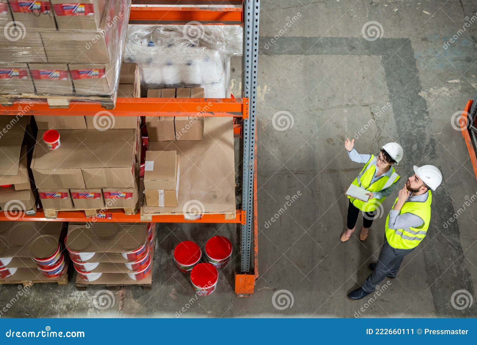 Two Workes of Warehouse in Uniform Having Discussion Stock Image