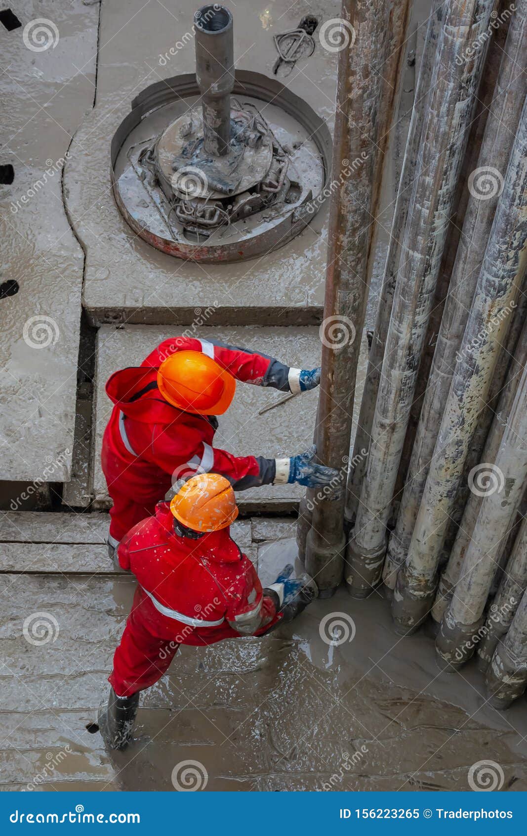 a working driller installs a drill pipe raised from a well.