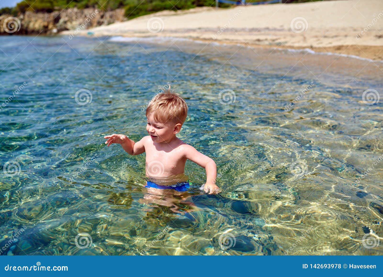 Toddler boy on beach stock photo. Image of smile, halkidiki 142693978