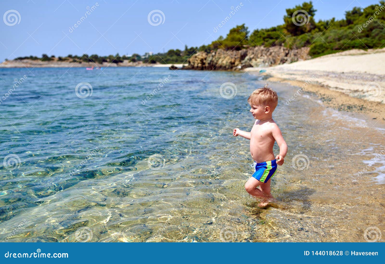 Toddler boy on beach stock photo. Image of scenic, cute 144018628