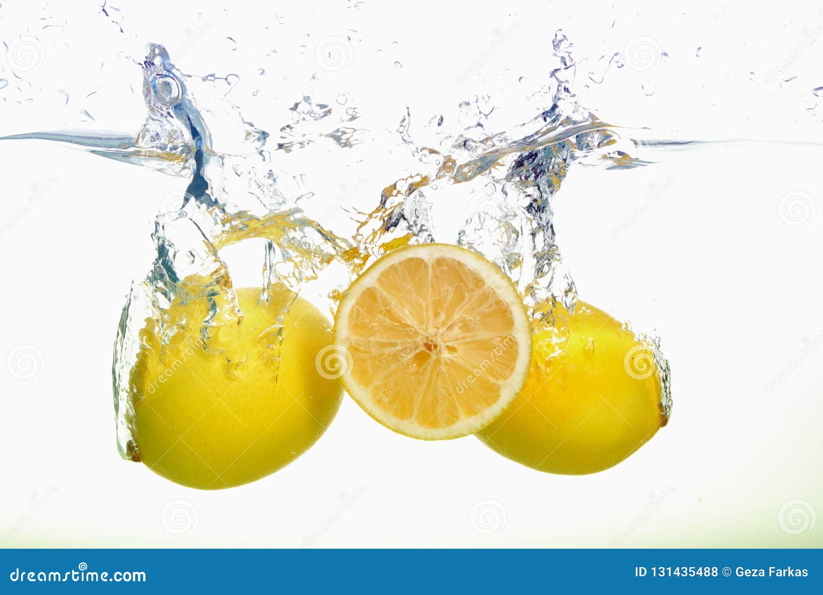 two yellow lemons and lemon slice spash in water on white background