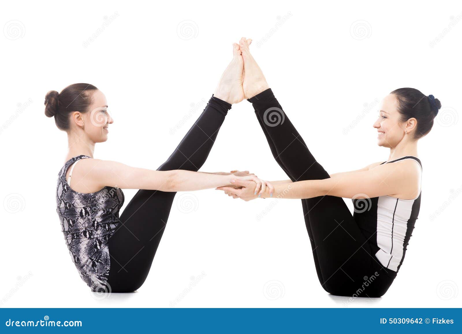 Two Yogi Female Partners in Balancing Stick Yoga Pose Stock Photo