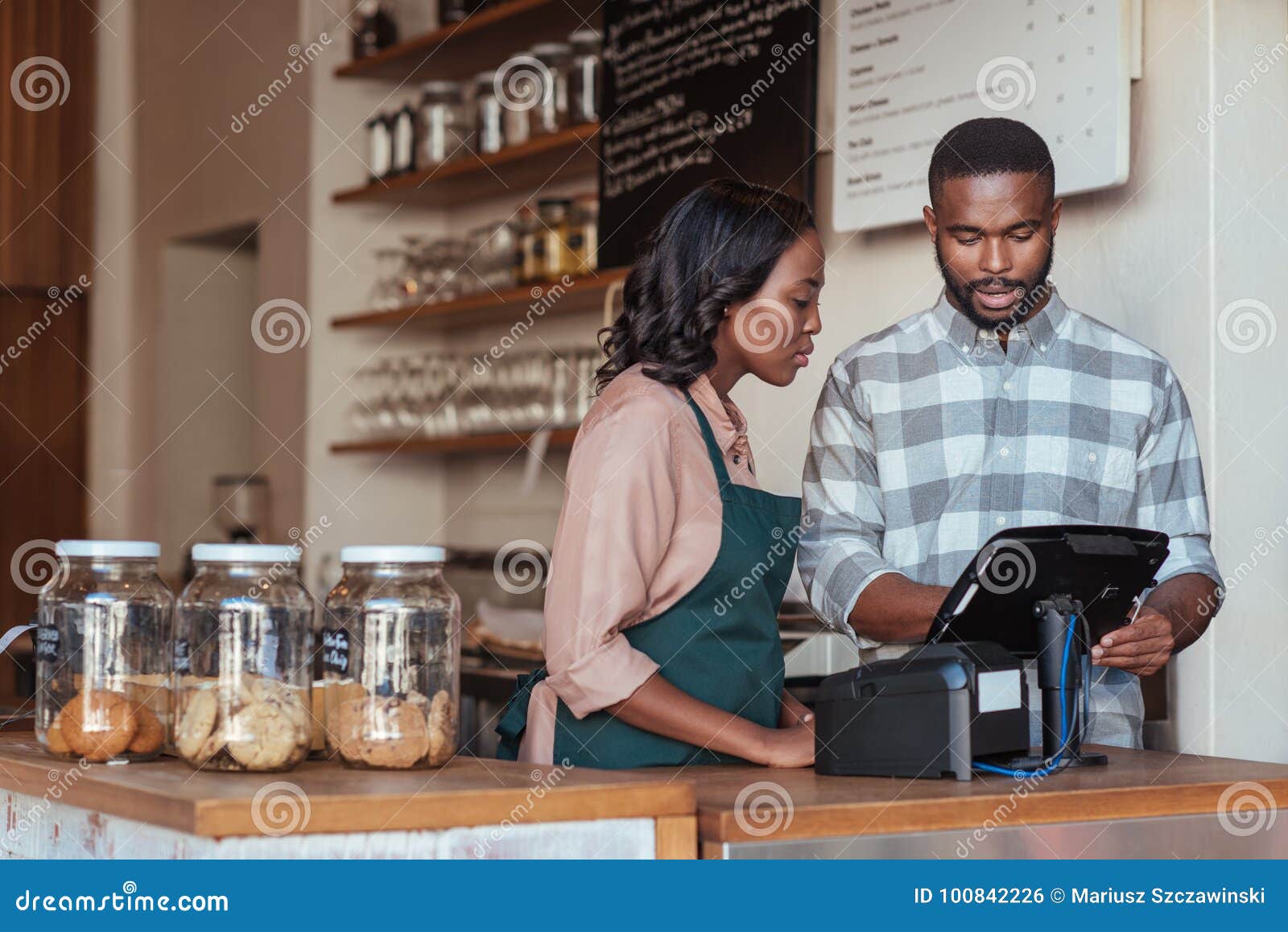 two african entrepreneurs working behind their cafe counter