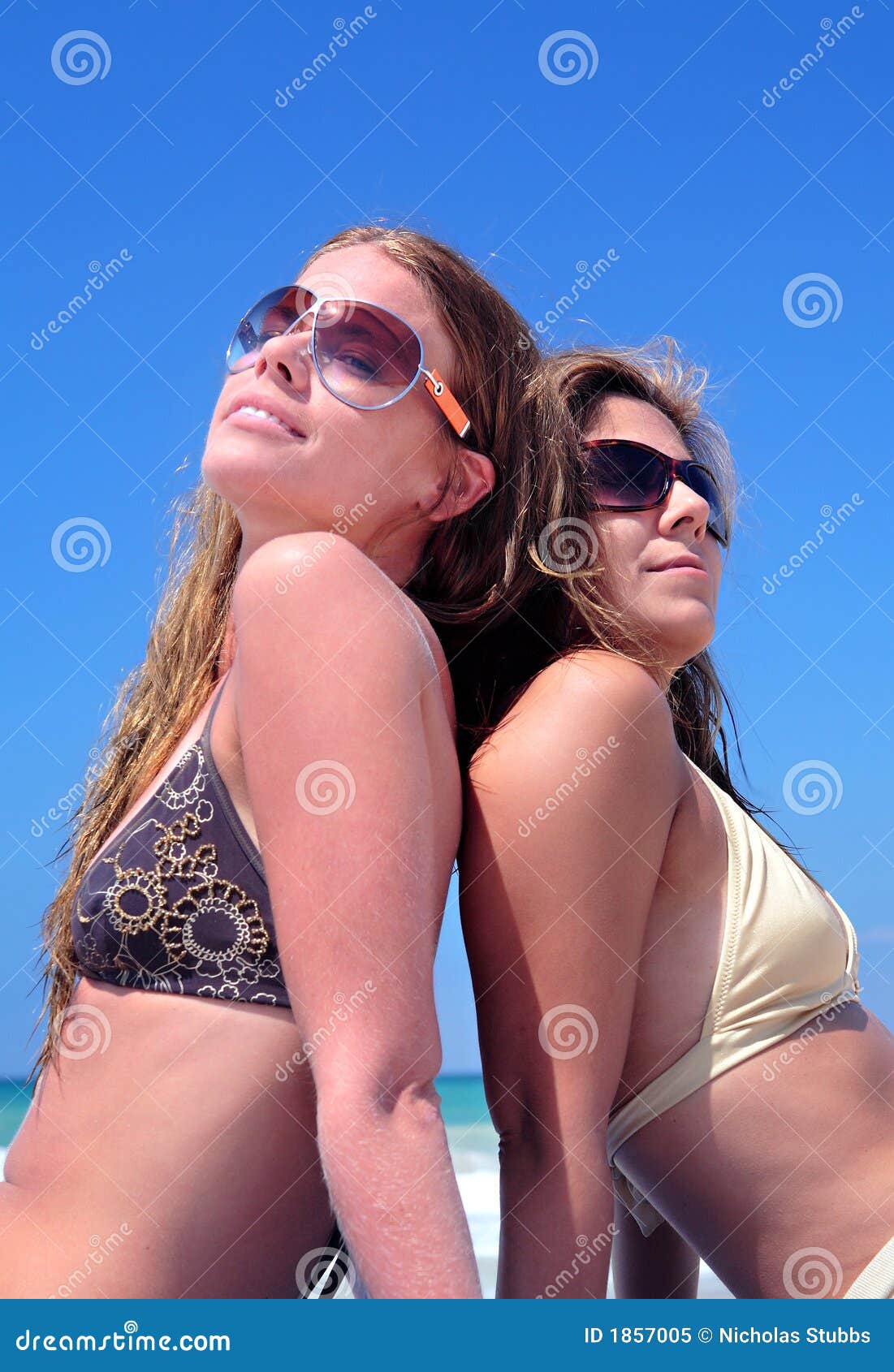 Two Young Attractive Women Chilling in the Sun on Holiday or Vac Stock Image