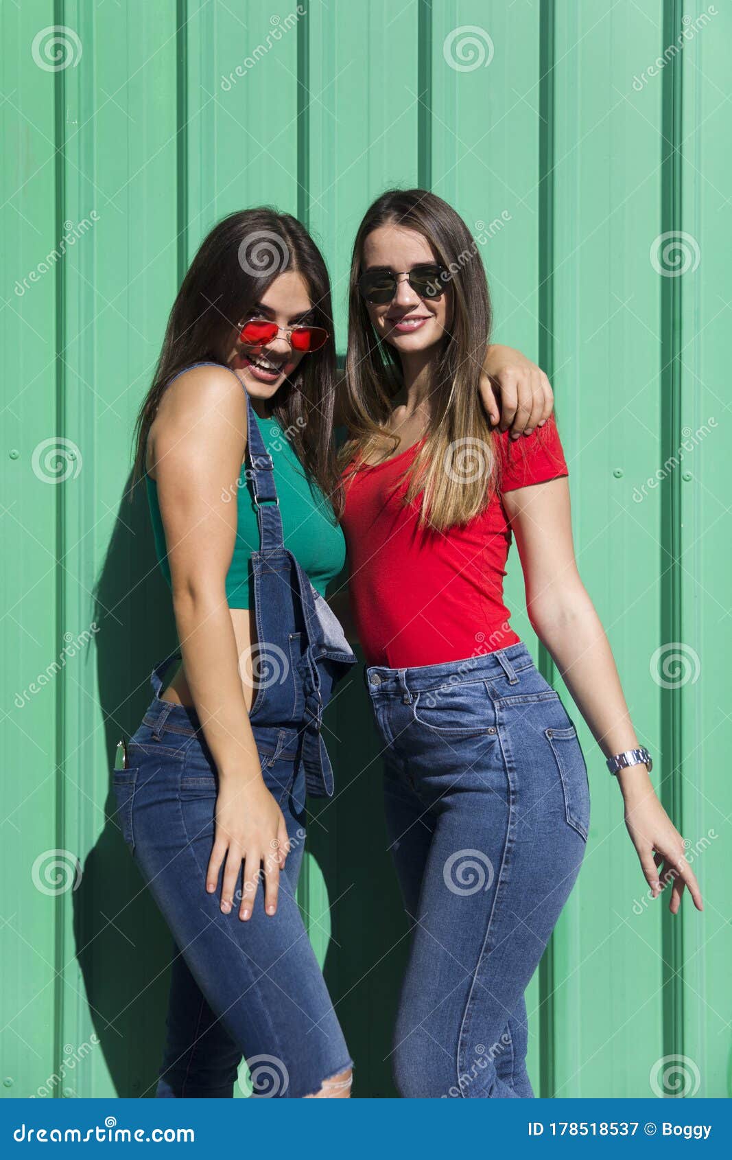 Two Young Best Female Friends Standing by the Green Wall Stock Image ...