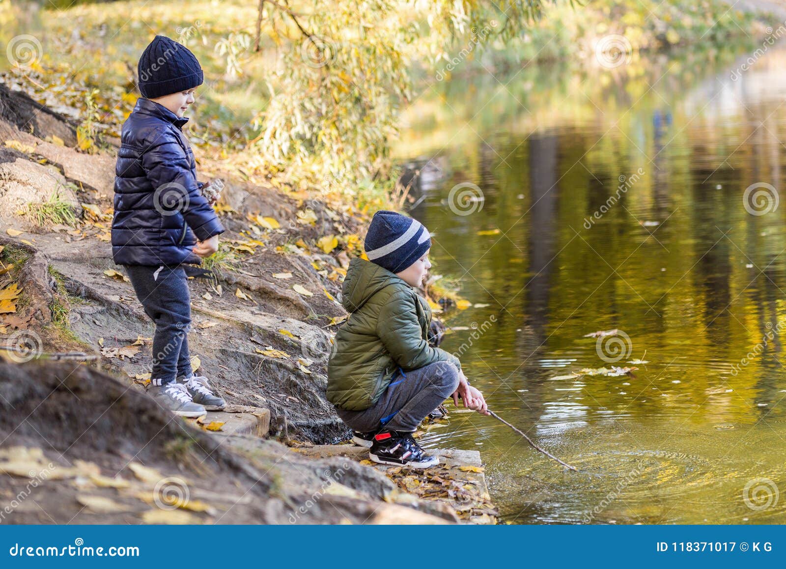 Two Young Boys Playing Fishing with Sticks Near Pond in Fall Park. Little  Brothers Having Fun Near Lake or River in Autumn Stock Image - Image of  childhood, leisure: 118371017