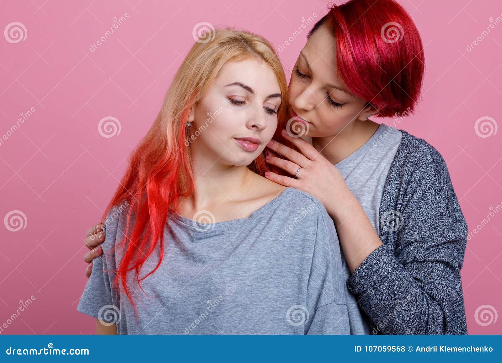 Two Lesbian Girls Gently Embrace And Caress Each Other On A Pink