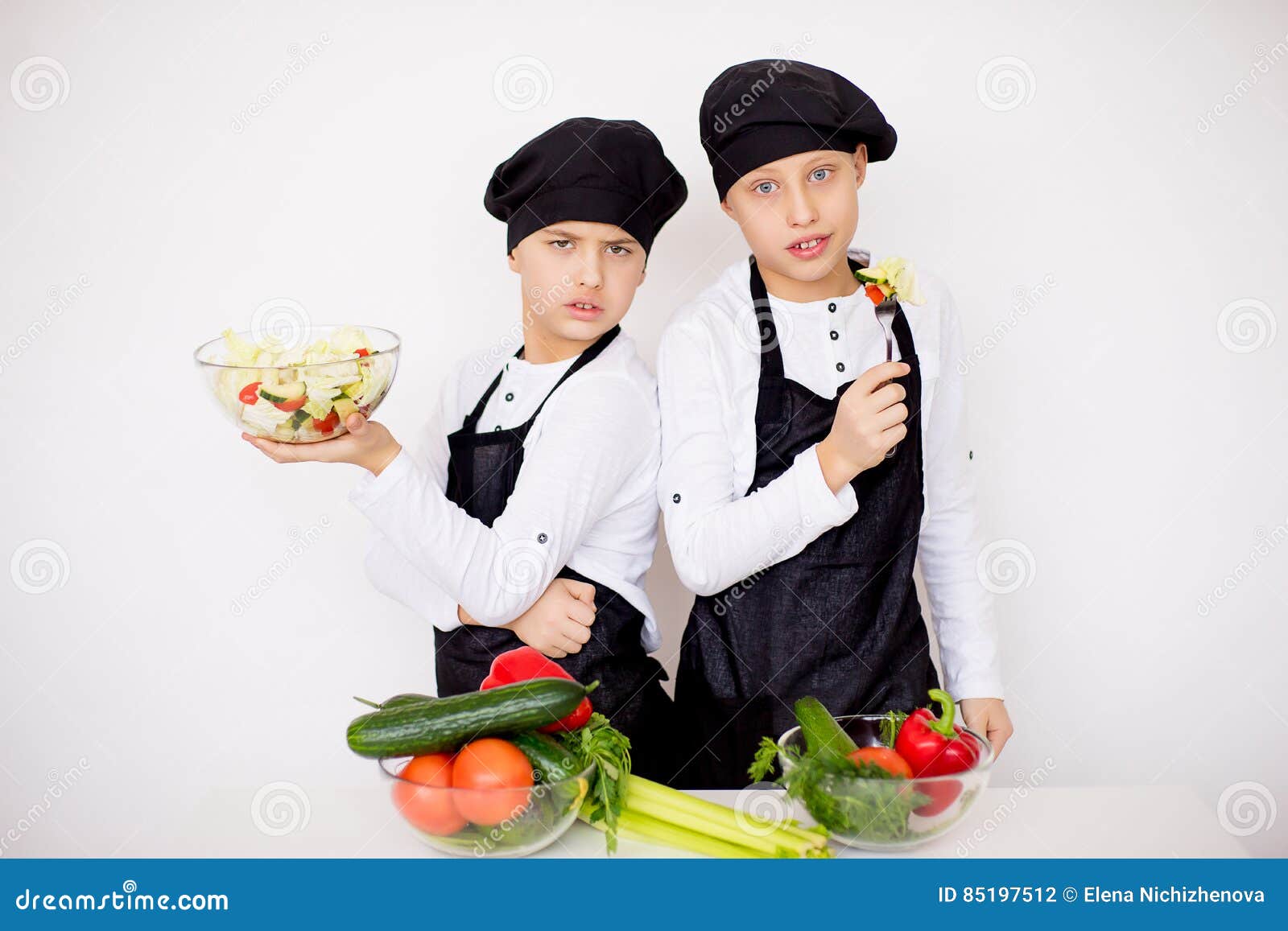 Two Young Chefs Evaluate a Salad Isolated Stock Photo Image of